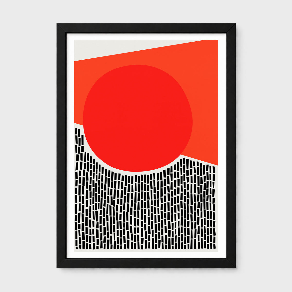 A framed abstract art print featuring a bold red circle, a red-orange geometric shape, and a black-and-white patterned lower section, displayed in a black frame against a light gray background.