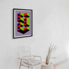 Geometric abstract art print on a wall above a chair