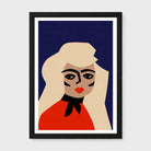 A framed minimalist art print featuring a stylized woman with blonde hair, a red top, and a black bow against a dark navy background, shown on a light gray wall.