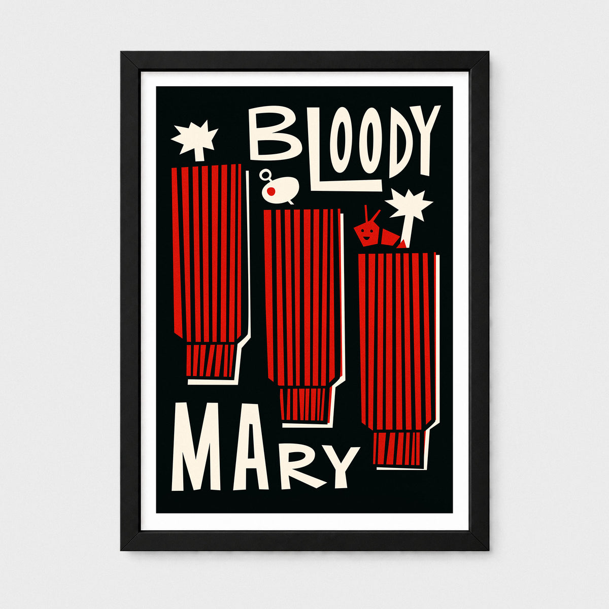 A framed graphic art print featuring three red striped cocktail glasses with the words 'BLOODY MARY' in bold cream lettering on a black background, shown against a light gray wall.