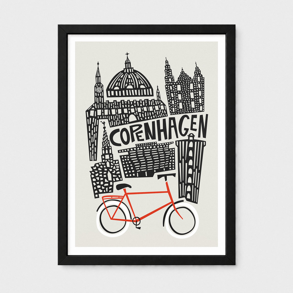 Framed art print featuring a black-and-white illustrated skyline of Copenhagen with the word 'COPENHAGEN' and a bright red bicycle at the bottom, shown against a light gray background.
