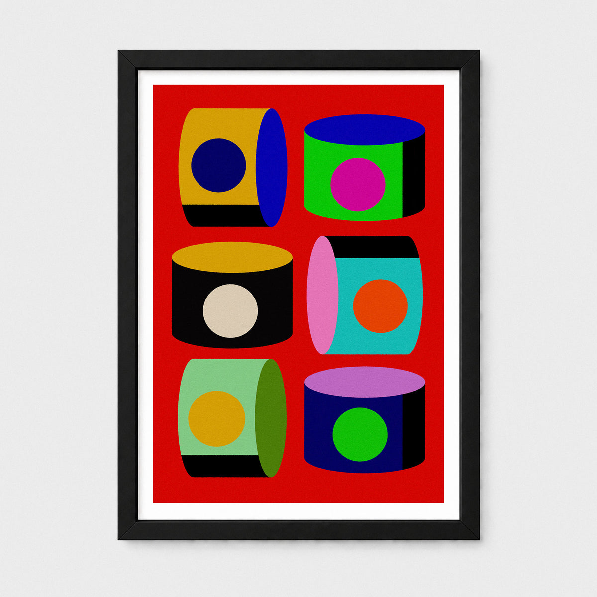 A framed pop art print featuring six colorful 3D cylinders with circular details on a bright red background, enclosed in a black frame with a white mat, shown against a light gray wall.