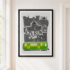 A framed art print featuring a stylized black and white map of Dublin with a green and yellow tram at the bottom, displayed on a white wall in a bright room.