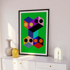 Geometric abstract art print on a white wall with decorative vases.