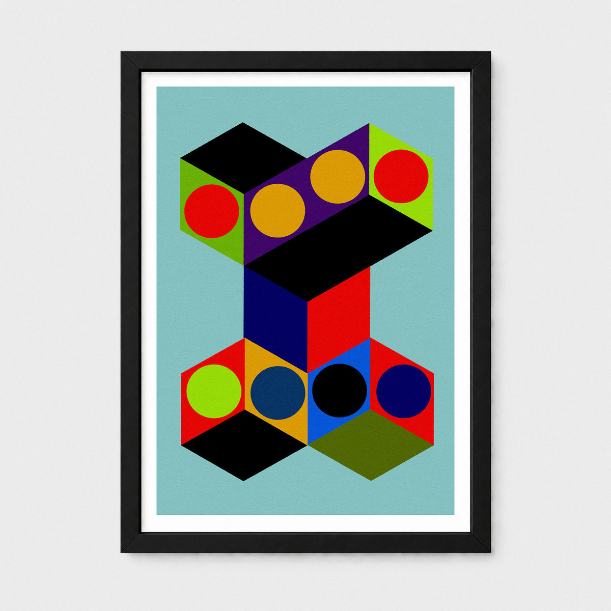 Framed abstract geometric wall art featuring overlapping black cubes with colorful circular and polygonal facets on a light blue background, shown in a black frame with white mat against a light gray wall.