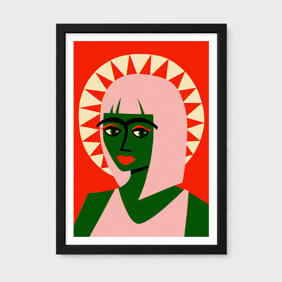 A framed art print featuring a stylized graphic portrait of a woman with green skin, a pink veil, and a red background with a cream sunburst halo. The print is framed in black with a white mat, shown against a light gray background.