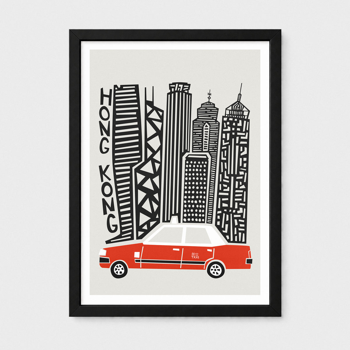 Framed art print featuring a stylized black and white illustration of Hong Kong skyscrapers with the word 'HONG KONG' written vertically, plus a red and white taxi at the bottom, shown in a black frame against a light gray background.