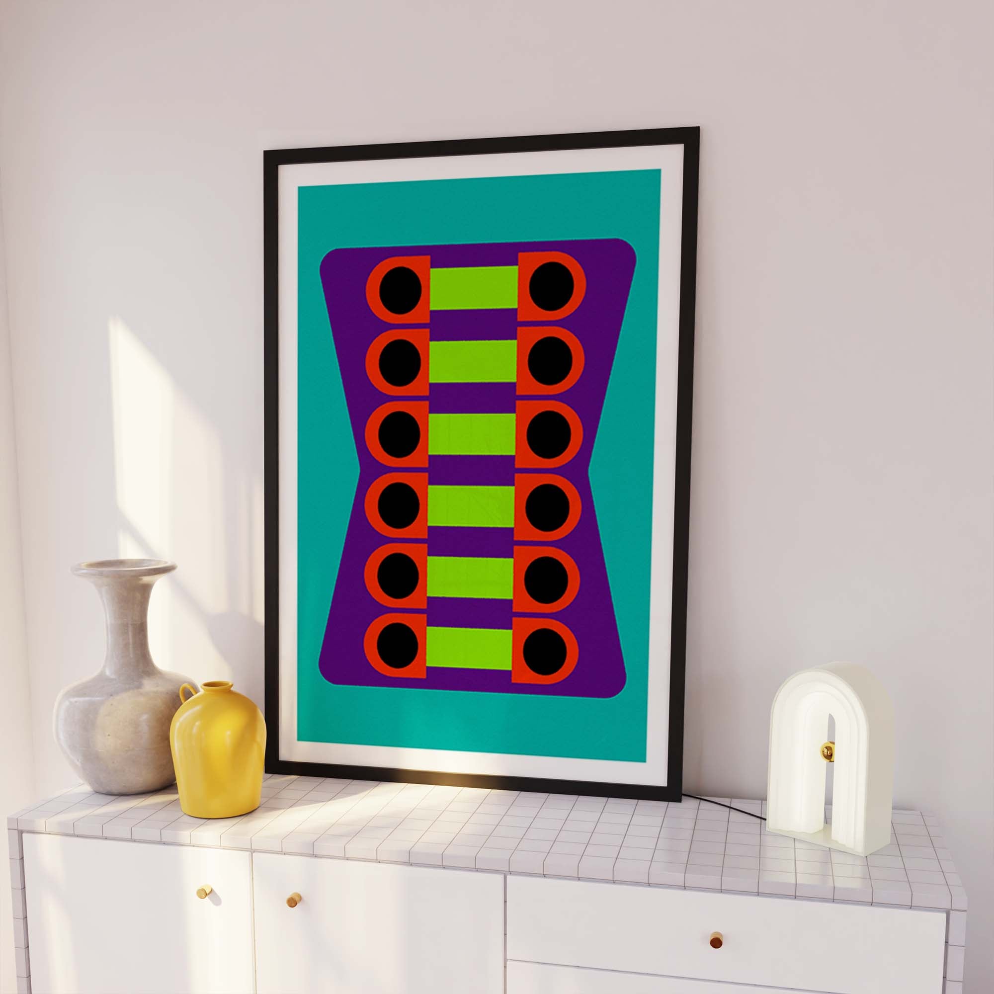 Framed abstract art piece with geometric design on a white wall
