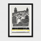 A framed art print featuring a stylized black and white illustration of the Los Angeles skyline with a yellow and black streetcar, shown against a light gray background.