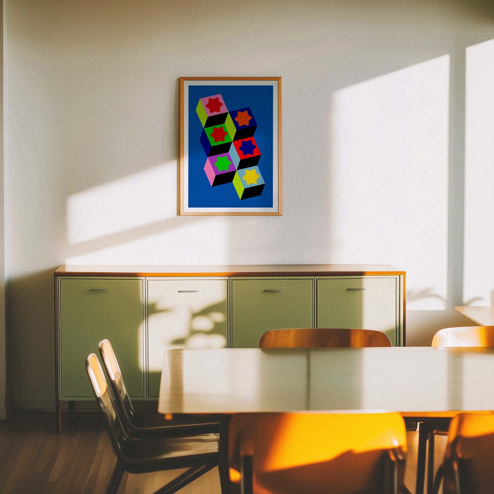Modern interior with a colorful abstract painting on the wall above a table and chairs.