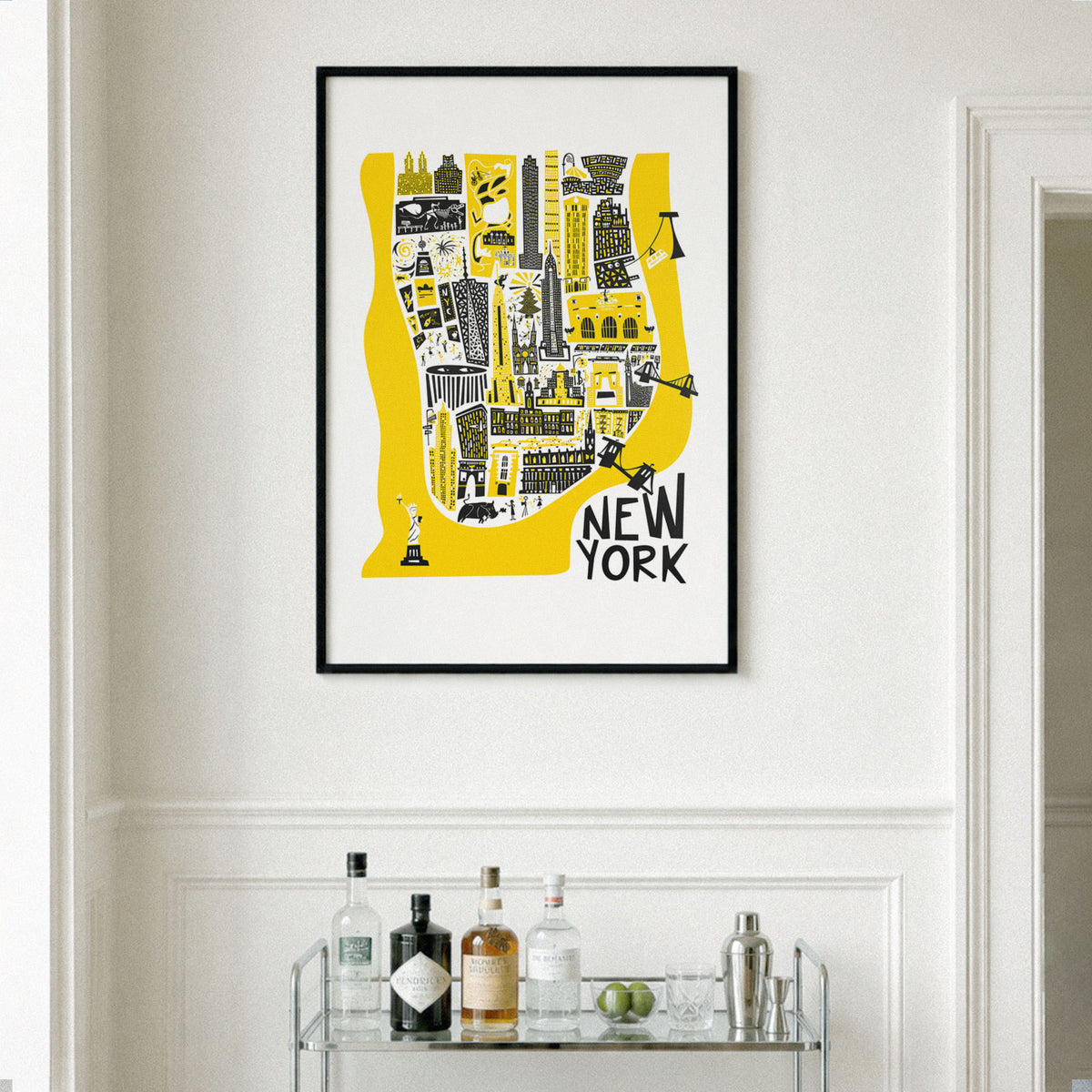 Manhattan map illustration in black frame on a cream wall next to a window, above a drinks cart.