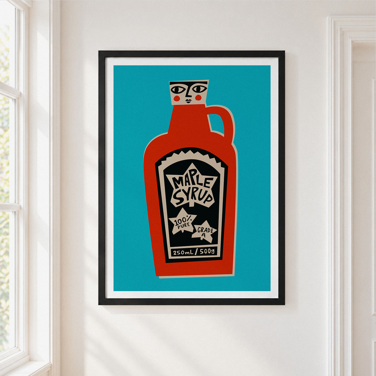 A framed art print featuring a stylized red maple syrup bottle on a bright teal background, hung on a white wall next to a window.
