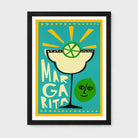 A framed art print featuring a stylized margarita illustration with the text 'MARGRITA' and a green lime character, shown against a light gray background.