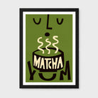 A framed art print featuring a stylized illustration of a steaming bowl of matcha with the word 'MATCHA' on the bowl and the phrase 'YUM' around it, shown against an olive green background with a black frame and white mat.