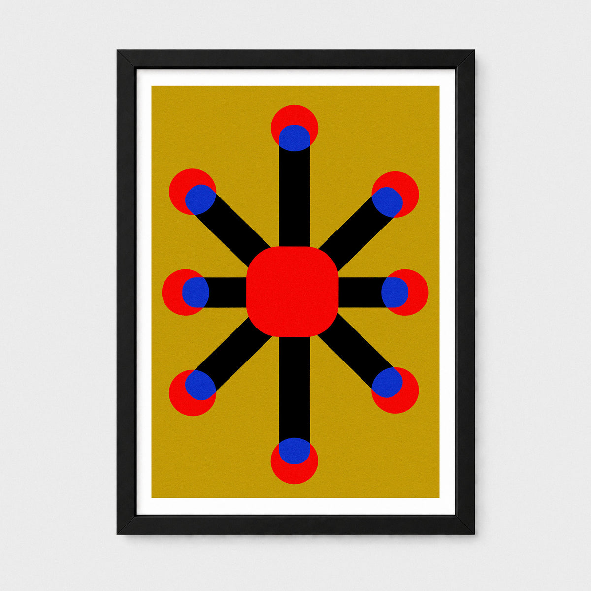 Framed abstract geometric wall art featuring a central red square connected to eight black radiating bars, each ending with red and blue circles, set against a mustard yellow background. The piece is housed in a black frame with a white mat, shown against a light gray wall.