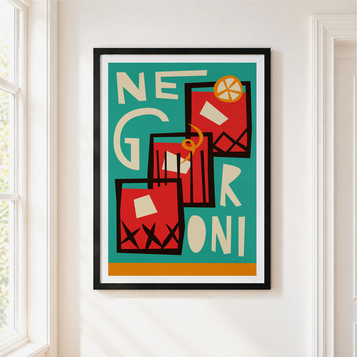 A framed abstract art print featuring the word 'NEGRONI' in cream lettering over red geometric shapes on a teal background, hung on a white wall next to a window.
