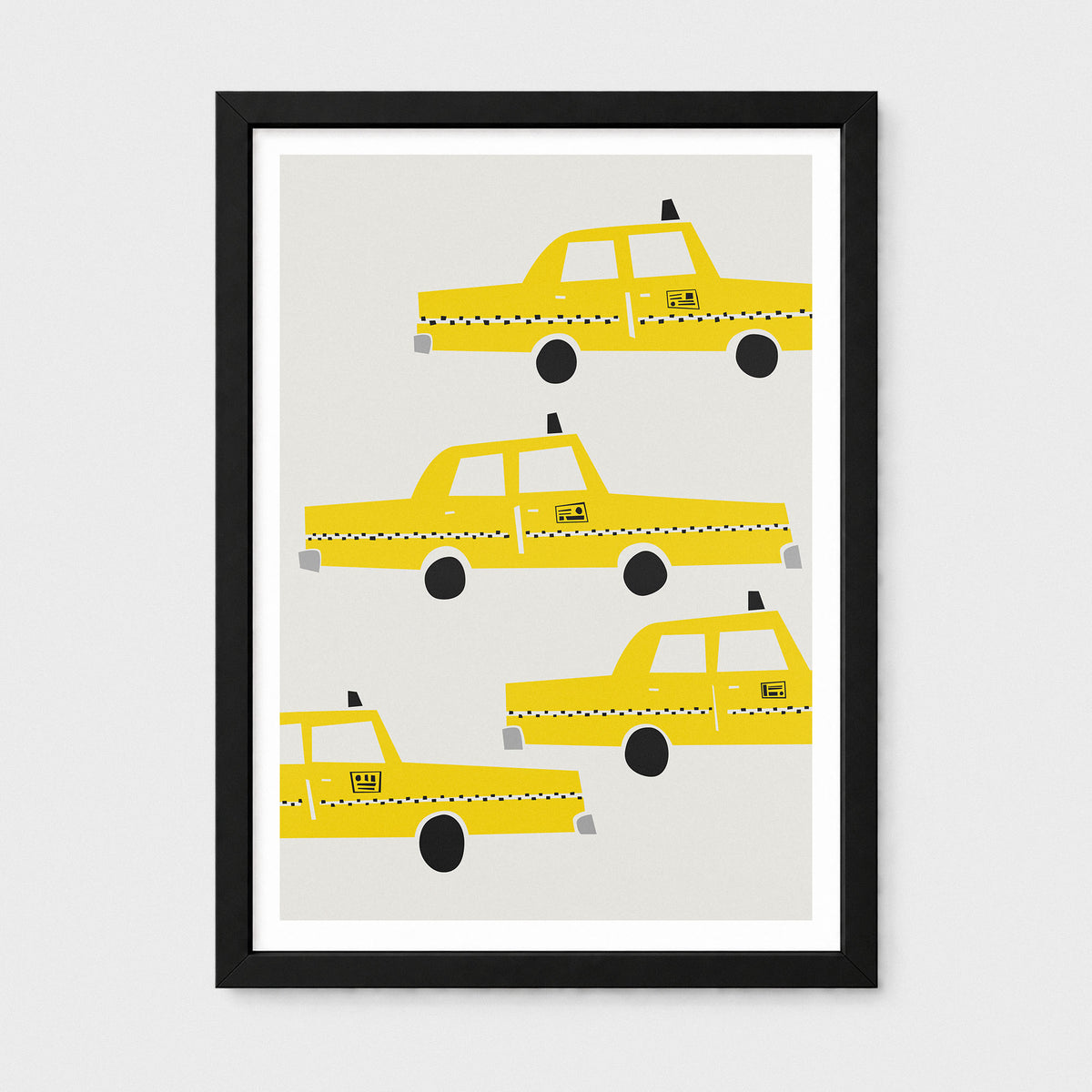 Framed wall art featuring four stylized yellow taxis on a light gray background, shown in a black frame with a white mat against a light gray wall.