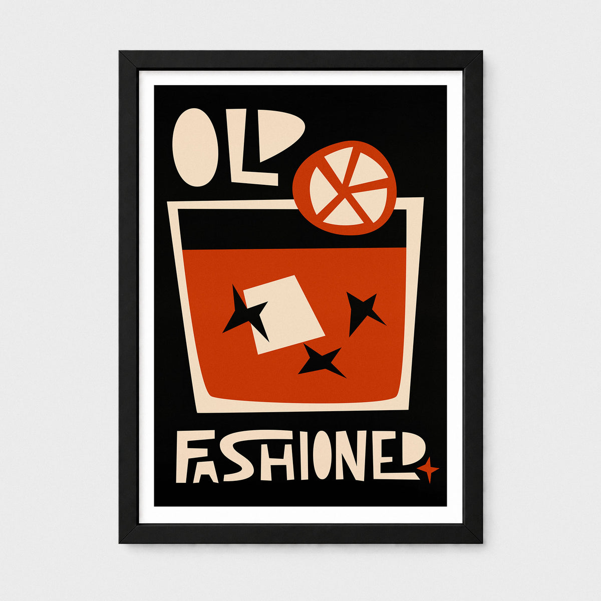 A framed vintage-style poster featuring a cocktail glass with orange-red liquid, cream lettering reading 'OLD FASHIONED,' and a black background, shown against a light gray wall.