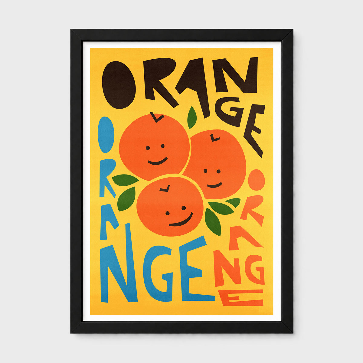 A framed art print featuring a retro-style illustration of three smiling oranges on a bright yellow background, with the word 'ORANGE' repeated in bold black, blue, and orange lettering. The print is housed in a black frame with a white mat, shown against a light gray background.