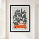 A framed art print featuring a stylized paris skyline with an orange car and black architectural details on a light gray background, hung on a cream-colored wall next to a window.