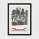 Framed Portland cityscape wall art print with black buildings, a bridge, the word 'PORTLAND,' and a white cable car with red stripes, shown in a black frame against a light gray background.