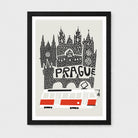 A framed travel art print of Prague, featuring a black and white hand-drawn illustration of the city's skyline and a red and white tram on a light beige background, enclosed in a black frame with a white mat.