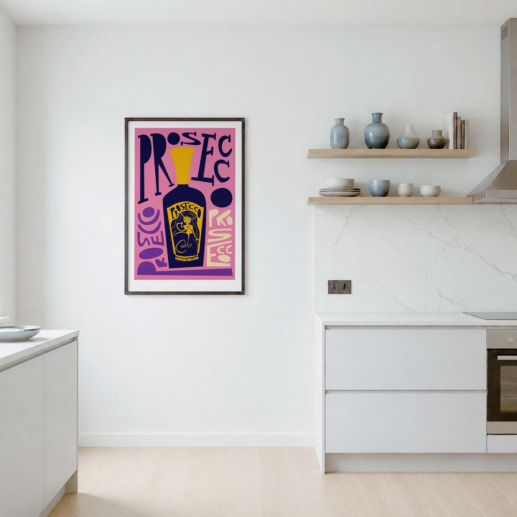 A framed art print featuring a purple and pink abstract design with a yellow bottle of prosecco illustration, displayed on a white wall in a modern kitchen setting.