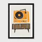 A framed art print featuring a retro orange and black stylized record player and matching striped sideboard on a light beige background, shown against a neutral light gray backdrop.