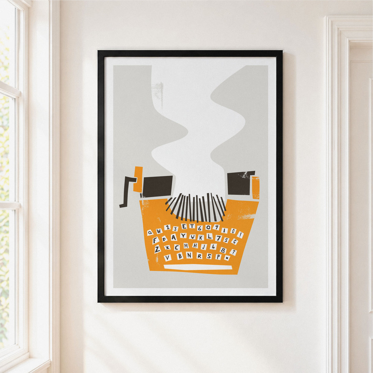 Framed minimalist typographic art print hanging on a white wall next to a window. The print features an orange computer keyboard with black keys and a black crank handle, with gray smoke-like wavy lines rising above it, all enclosed in a black frame.