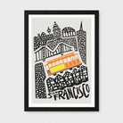 Framed San Francisco cityscape art print with black line drawings of buildings and a bright orange and yellow cable car on a light gray background, shown in a black frame against a light gray wall.