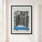 A framed art print featuring a stylized black and white skyline with the word 'SINGAPORE' and a blue taxi at the bottom, hanging on a light beige wall next to a window.