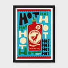 A framed art print featuring a stylized graphic of a Skirachi hot sauce bottle surrounded by bold retro text on a turquoise background, enclosed in a black frame against a light gray wall.
