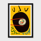Framed minimalist sushi art print with a bold yellow background, a large black oval, chopsticks, stylized text, and a small fish illustration, shown against a light gray wall.