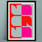 Framed abstract art print with geometric shapes in red and pink on a gray background