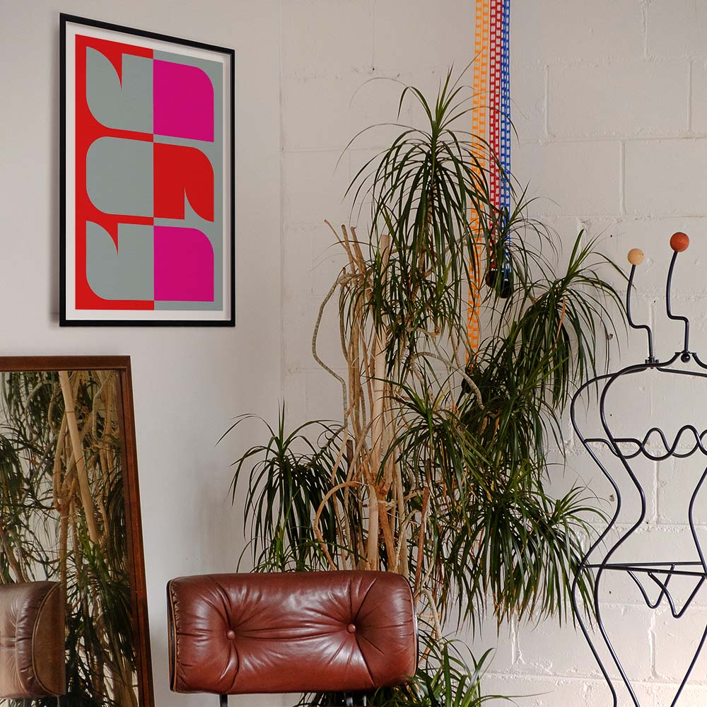 Room interior with a red leather chair, plants, and abstract art on the wall.