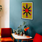 Modern living room with abstract art, red chair, and plants on a blue wall.