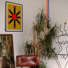 Modern interior with abstract art, plants, and a brown leather chair.