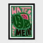 A framed art print featuring a stylized watermelon illustration with the word 'WATERMELON' in pink and 'MELON' in dark brown, set against a green background and displayed on a light gray wall.