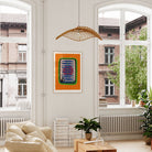 Anchovies poster hanging in bright city flat above cream sofa and indoor plants