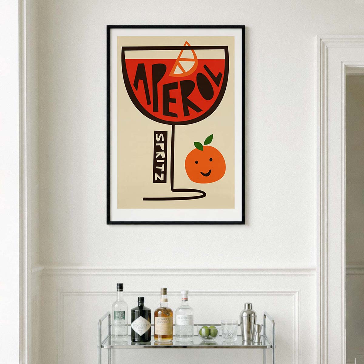 Aperol spritz print in a black frame above a drinks cart.