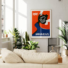 Aquarius zodiac poster framed above a neutral sofa in a bright, plant-filled lounge with soft natural light.