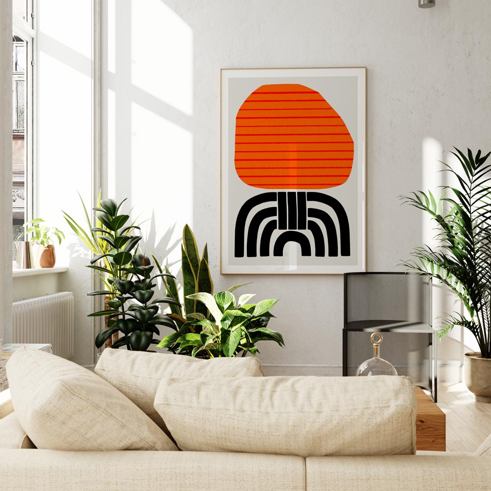 The Aurelia print hung above a beige sofa, where its high-contrast colours and retro form give the neutral space a playful and graphic focal point.

