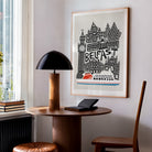 The Belfast city art print styled in a cosy corner studio, its dynamic composition and monochrome skyline energising the space with urban flair.