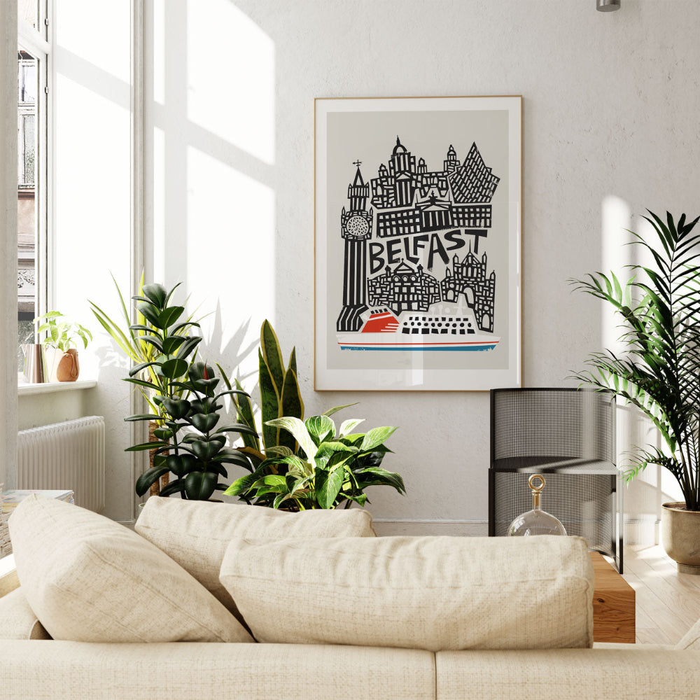 The Belfast print framed in a contemporary living room, framed by lush indoor plants and natural light, offering a graphic tribute to the city’s heritage.