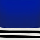 Close-up of cobalt blue block and curved black linework on white background