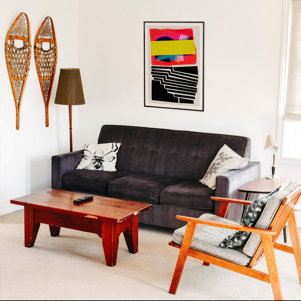 Abstract geometric print with strong pink, yellow, and black elements adding contrast to a contemporary lounge.