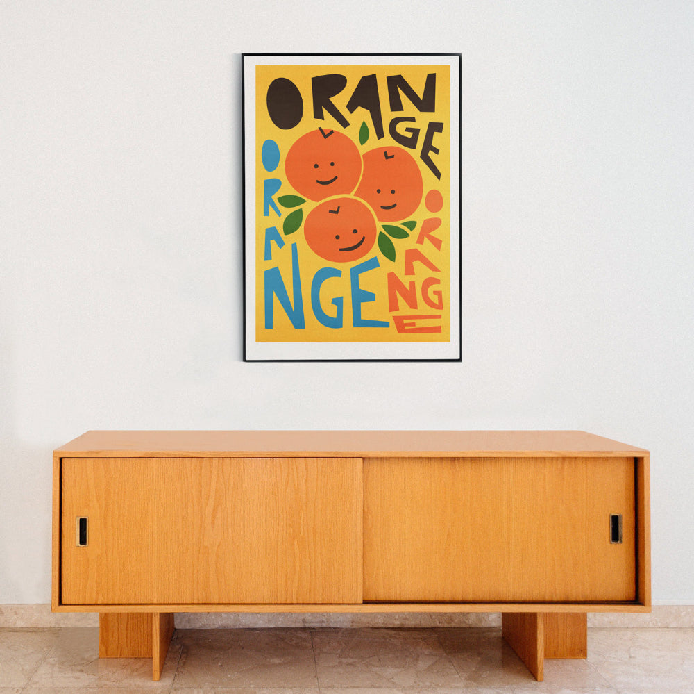 Fun fruit poster styled above a minimalist wooden sideboard.