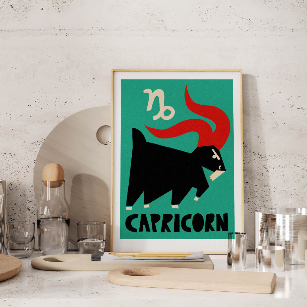 Capricorn zodiac poster framed on a stone-textured shelf with cocktail glasses and minimalist decor.