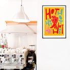 Colourful hot pepper print displayed above a home espresso setup.