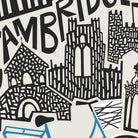 A close-up of a graphic print featuring stylized black line-art illustrations of Cambridge landmarks, including a cathedral and bridge, with large partial text reading 'CAMBRIDGE.